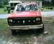 1985 Ford Bronco - Front view of a red Ford Bronco with a skull emblem on the grille and aftermarket modifications.
